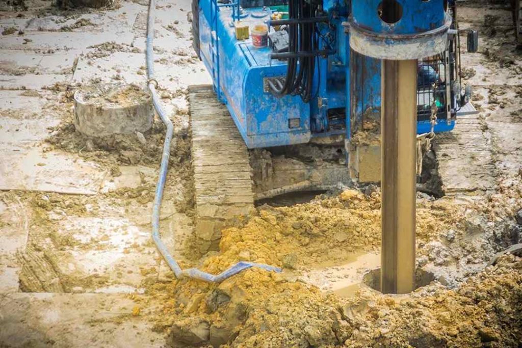 Installation d'un piézomètre lors d'une étude hydrogéologie pour surveiller le niveau de la nappe phréatique.